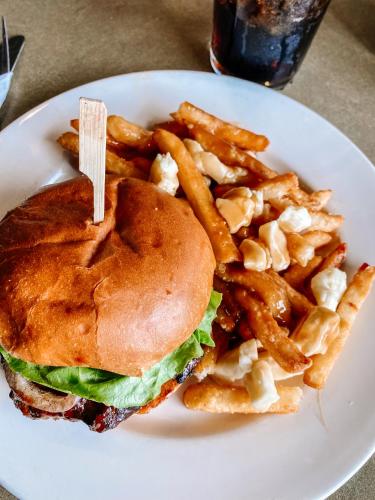a sandwich and french fries on a white plate at La Place Rendez-Vous Hotel in Fort Frances