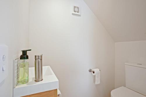 a bathroom with a sink and a toilet at Addington Delight - Christchurch Holiday Home in Christchurch