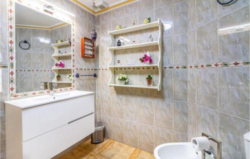 a bathroom with a sink and a mirror at Stunning Apartment In Orihuela Costa With Outdoor Swimming Pool in Playas de Orihuela