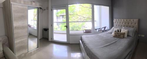 una camera con un grande letto e una grande finestra di Loft Espectacular Céntrico con Garaje a Rosario