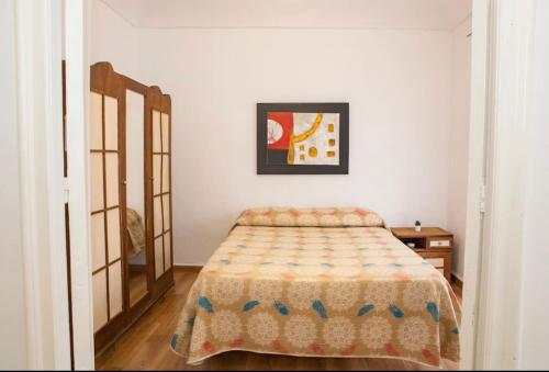 1 dormitorio con 1 cama y una foto en la pared en Apartamento deluxe Terraza y bbq, en Santa Amalia