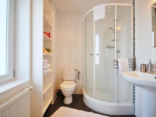 a bathroom with a shower and a toilet and a sink at Comfortable apartment with a balcony, very close to the sea, Ustronie Morskie in Ustronie Morskie