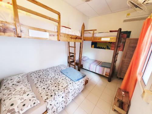 a bedroom with two bunk beds in a room at Divanga Hostel and Diving in Taganga