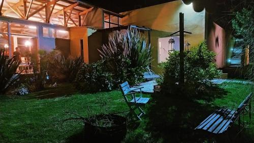 a couple of benches sitting in a yard at night at Amonita casa Campestre, vía Tunja Paipa in Tunja