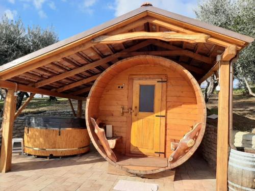 a large wooden hobbit house with a large wooden door at Charming Escape in Modigliana in Modigliana