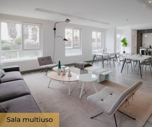 a living room with a couch and tables and chairs at La herradura departamento nuevo a pasos de la playa 2 dorm 1 baño in Coquimbo