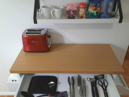 a shelf with a toaster sitting on top of a drawer at Pet Friendly Apartment minutes from NYC! in West New York