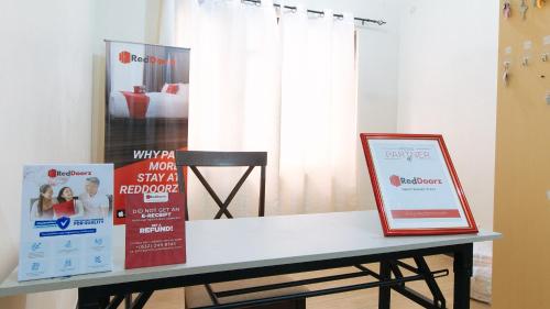 a table with a sign on it in a room at RedDoorz @ Classique Pan Oriental Hotel and Resort Batangas in Batangas City