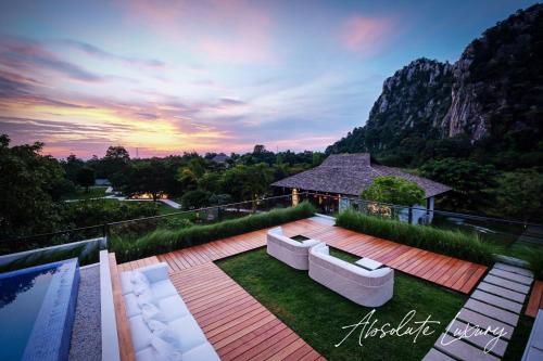 a patio with two white couches on a deck at The Soul Resort in Sara Buri