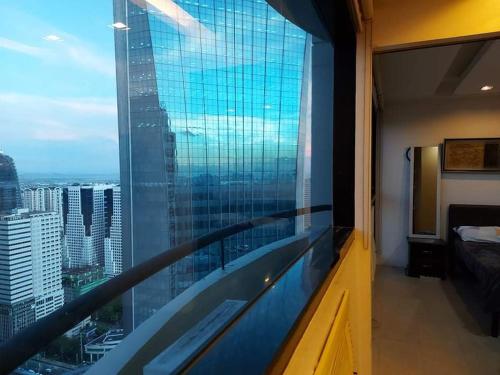 a room with a large window with a view of a city at Family Staycation with Pool in Manila
