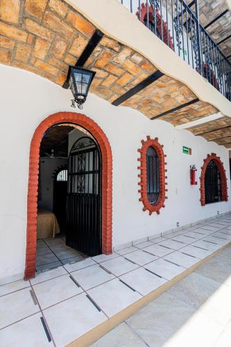 a building with a black gate and a staircase at Bungalows Maria Teresa in Rincon de Guayabitos