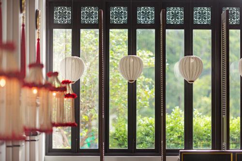 a room with a window with four lamps in front at The Soul Resort in Sara Buri