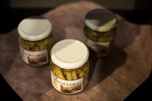 three jars of pickles sitting on a table at Hotel Kitanoya in Miyazu