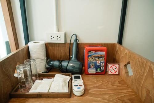 a wooden box with a cell phone in it at CozyHouse near MRT QSCC Convention Center 4BR 10ppl in Bangkok