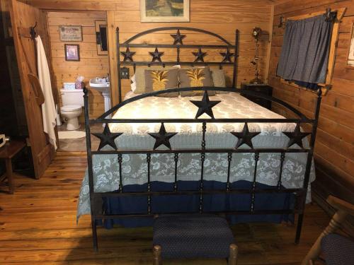 a bedroom with a black bed with stars on it at Country Accents - Lee Cabin in Pipe Creek
