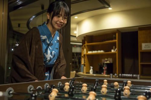 a woman standing in front of a chessboard at Hotel Kitanoya in Miyazu