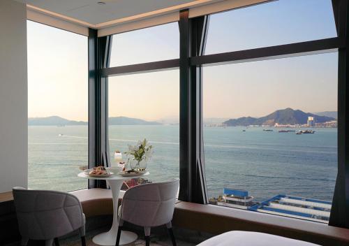 a dining room with a view of the water at One-Eight-One Hotel & Serviced Residences in Hong Kong