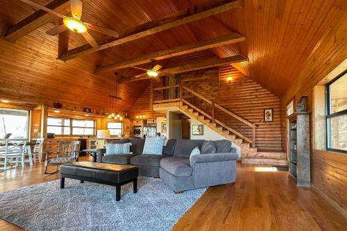 a living room with a couch and a table at Charming Cabin with Hot Tub, Fire Pit and Views! in Jasper