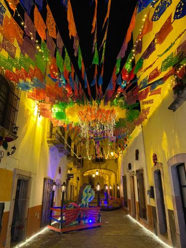 un couloir d'un bâtiment avec un lustre et des drapeaux dans l'établissement Hotel Casa Santo Domingo, à Zacatecas