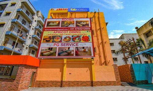 a sign on a building in front of a building at FabHotel Empire Executive - Nr HINJEWADI PHASE 1 in Pune