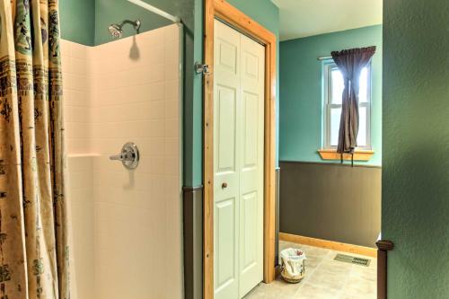 a bathroom with a shower with a glass door at Cloudcroft Home with Spacious Stargazing Deck! in Cloudcroft