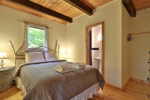 a bedroom with a bed with towels on it at Left Duplex Home Directly Across From Pico Mountain, Close to Killington, home in Killington