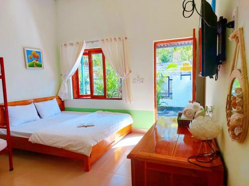 a bedroom with a bed and a window at Ben Guesthouse Phu Quoc in Phu Quoc