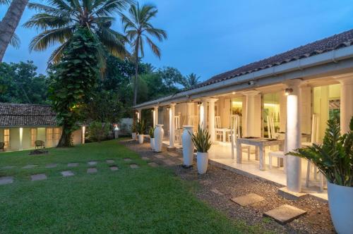 a building with a yard with a table and chairs at W15 Escape in Ahangama