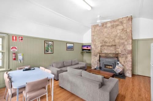 a living room with a couch and a fireplace at Breeze Holiday Parks - Halls Gap in Halls Gap