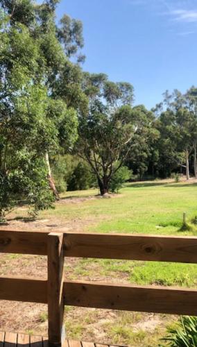 a wooden bench in a park with a field at Don Valley Lodge in Launching Place