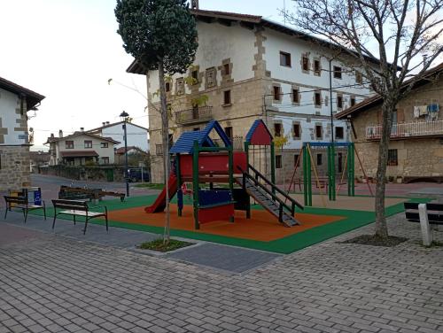 a playground with a slide in a park at Apartamentos Herri Ondo REFUGIO CLIMATICO in Iturmendi
