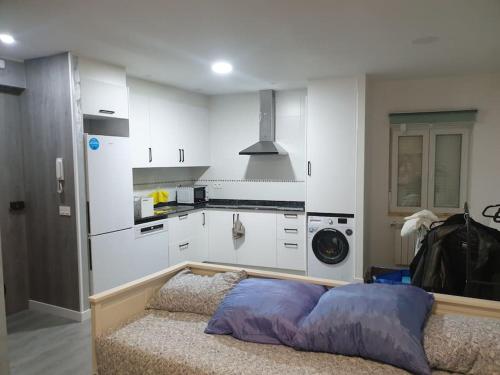 a kitchen with a bed in the middle of a room at Logroño Centro Home in Logroño