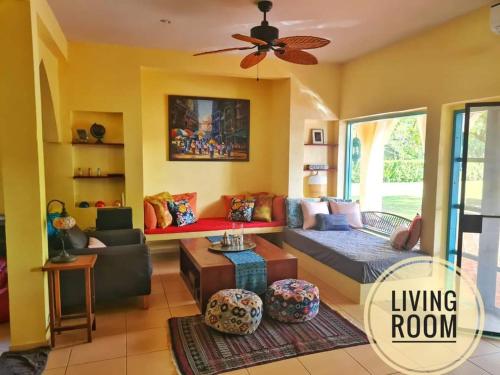 a living room with a couch and a living room at Kampu Nature Pool Villa Rayong in Rayong