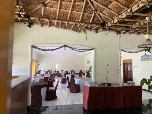 a banquet hall with tables and chairs in a room at Hotel Puspa Sari in Ciater