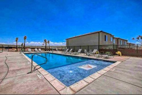 a swimming pool with chairs and a building at Southern Retreat, Priv Patio with Hot Tub, Zions. in Washington