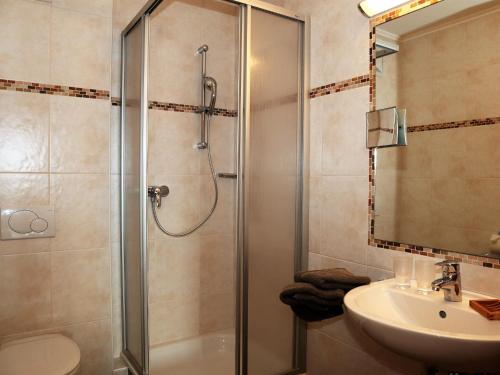 a bathroom with a shower and a sink at Apartments Filzsteinalm, Hochkrimml in Kirchdorf
