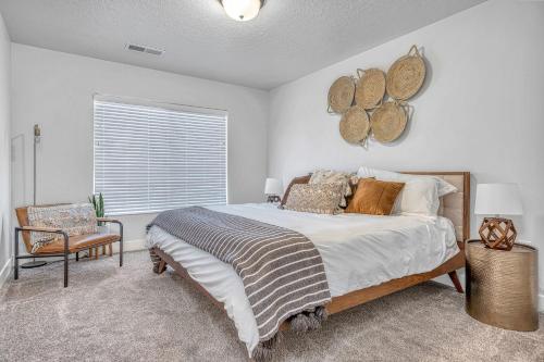 a bedroom with a bed and a chair and a window at Southern Retreat, Priv Patio with Hot Tub, Zions. in Washington