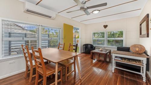 a dining room with a wooden table and chairs at 92 Landsborough Parade Golden Beach in Golden Beach