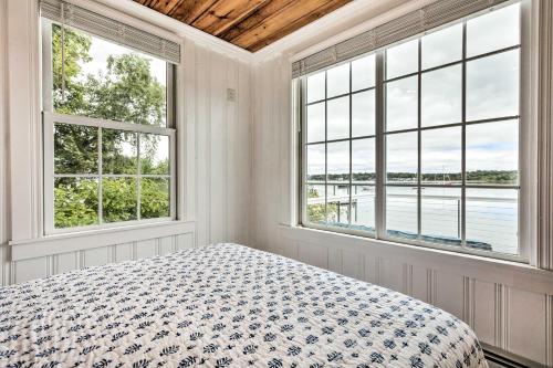a white bedroom with two windows and a bed at Charming Bristol Cottage with Private Beach! in Bristol