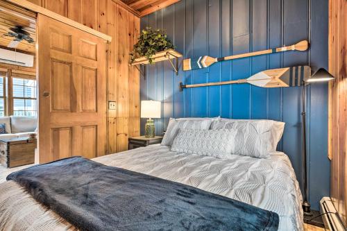 a bedroom with a bed and a blue wall at Charming Bristol Cottage with Private Beach! in Bristol