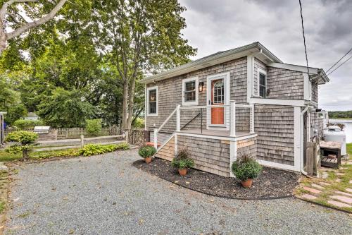 a tiny house with a red door in a driveway at Charming Bristol Cottage with Private Beach! in Bristol