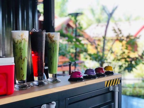 a table with three drinks on top of it at กอบสุข รีสอร์ท2 k04 in Ban Ton Liang
