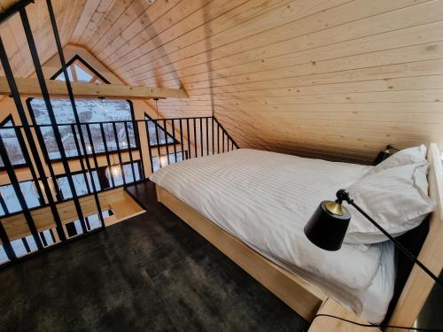 a bedroom with a bed in a wooden cabin at Heart and Soul in Tylmanowa