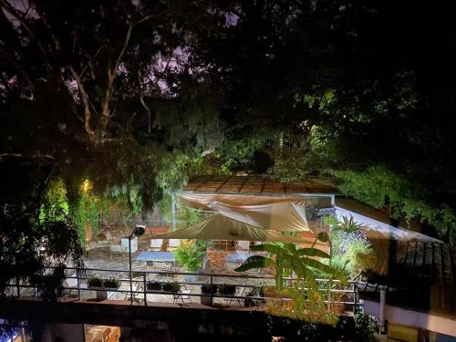 a patio with a table and an umbrella at Kunming Upland International Youth Hostel ,near the city center ,2 mins walk to the subway, 2 mins walk to the Green Lake, Close to Yuan tong Temple, Old street, Yunnan University, convenient payment and visa cards are accepted in Kunming