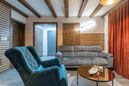 a living room with two chairs and a couch at Mila house Tara in Bajina Bašta