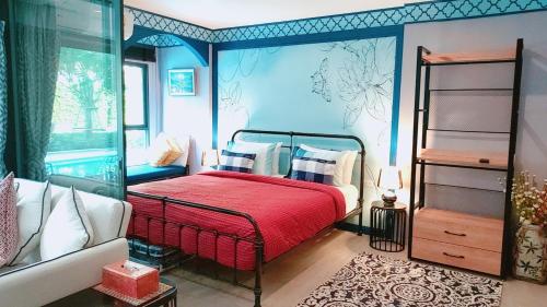 um quarto com uma cama com um cobertor vermelho em New. Beautiful One Bedroom Pool Access Condo. Only 200 metres to the beach. em Hua Hin