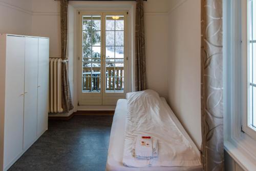 Postel nebo postele na pokoji v ubytování Zentrum Haus Davos