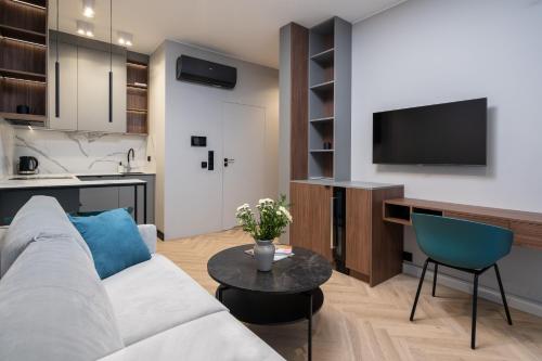 a living room with a couch and a table at Apartamenty Olimpijska by RENT4YOU in Olsztyn