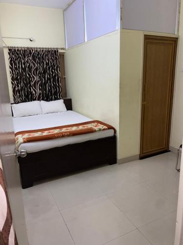 a bedroom with a bed in a room at Lake Land Guest House in Kolkata