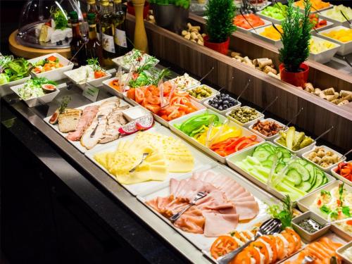 a buffet filled with lots of different types of food at Qubus Hotel Wrocław in Wrocław